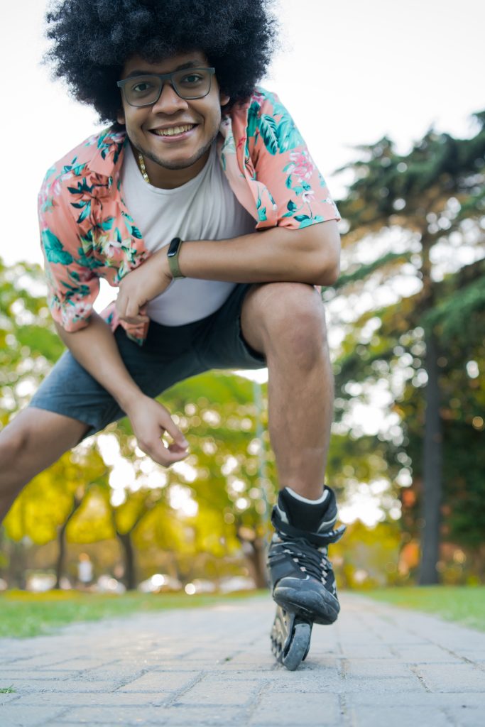 latin man rollerskating outdoors EL4T2YG
