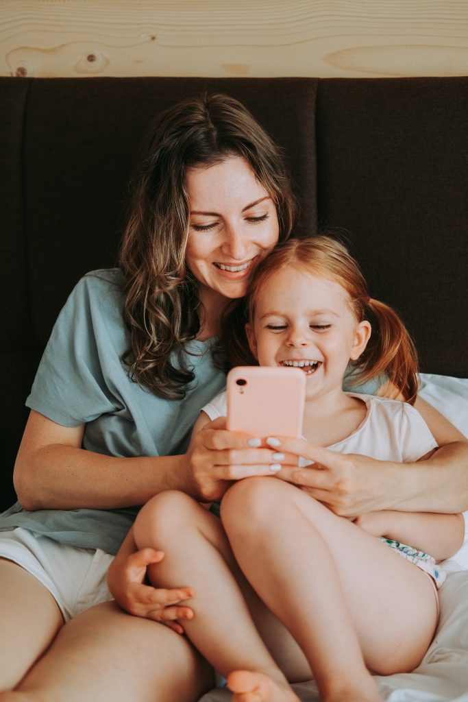 mother and her daughter use smartphone TW8PJG6